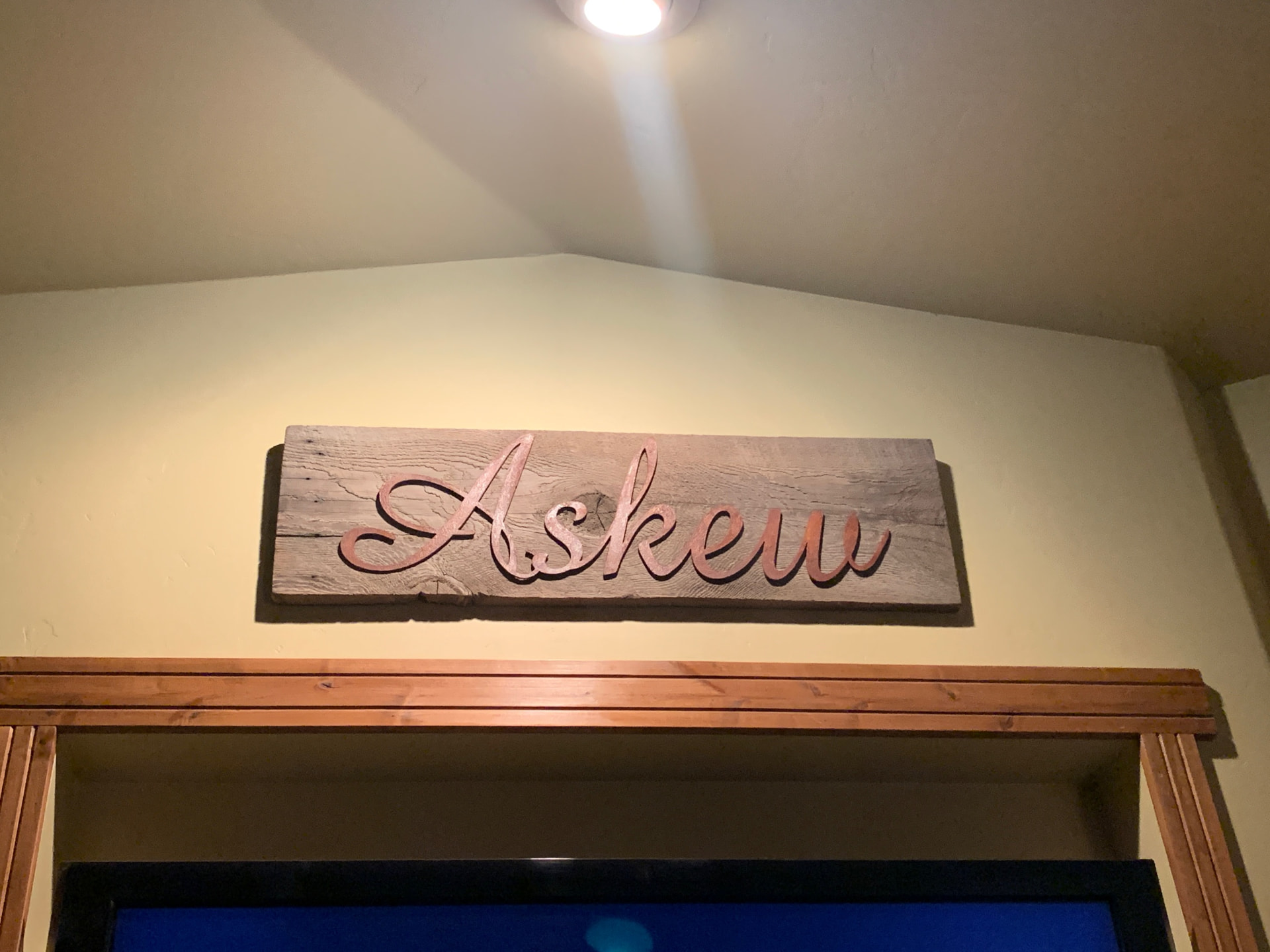 Copper finished cut metal script name sign mounted on reclaimed barnwood