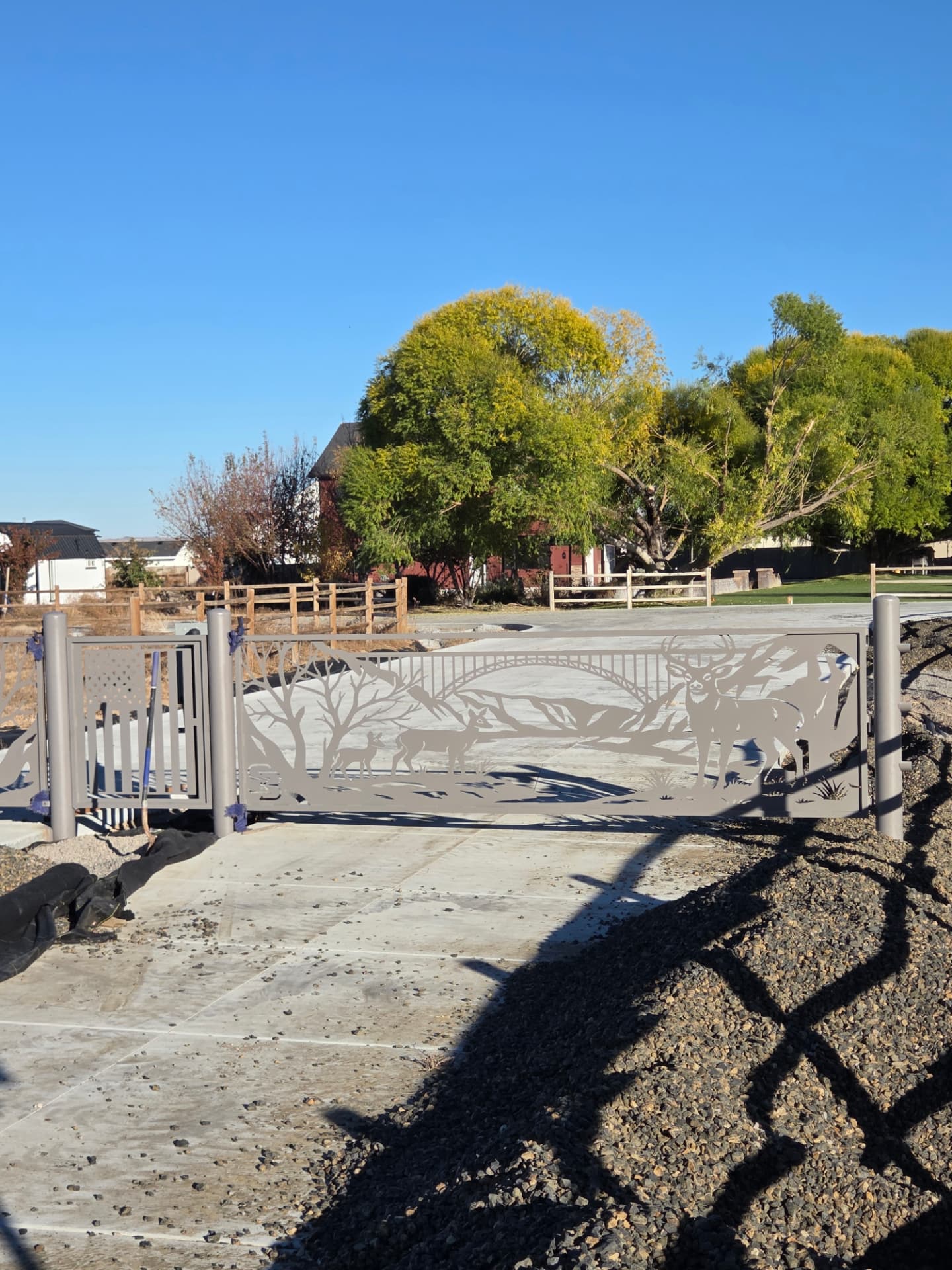 Sliding driveway gate with CNC-cut deer and mountain scene panel
