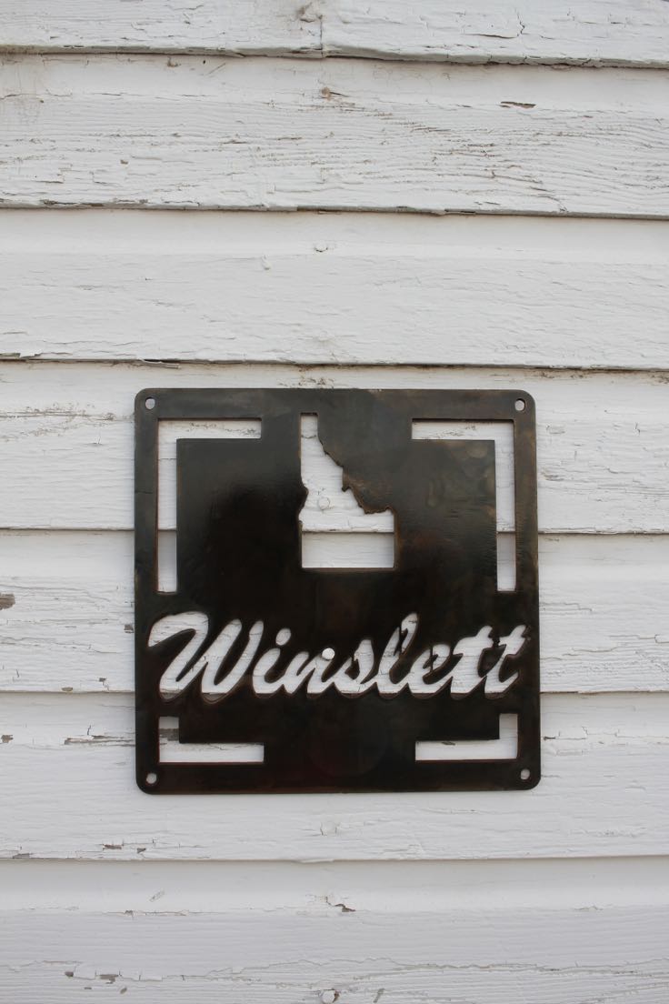 Square steel plaque with Idaho state cutout and script family name